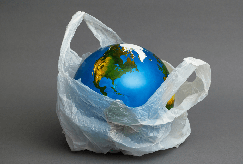 A globe of the Earth in a single use plastic bag
