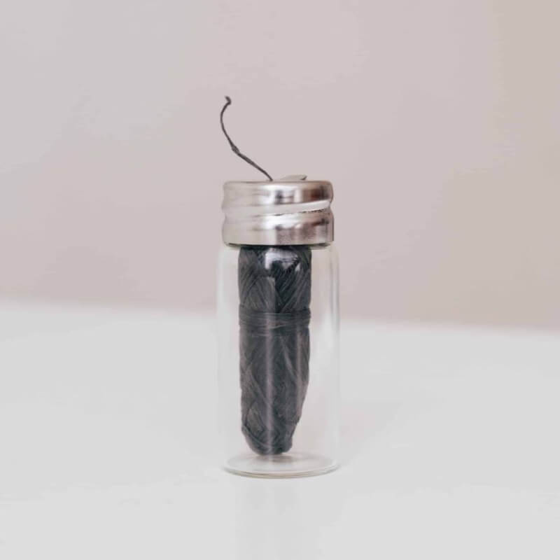 Compostable strong bamboo charcoal dental floss in a reusable glass container